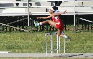 Sophomore Tomarri Lee jumping in the 100 hurdles event