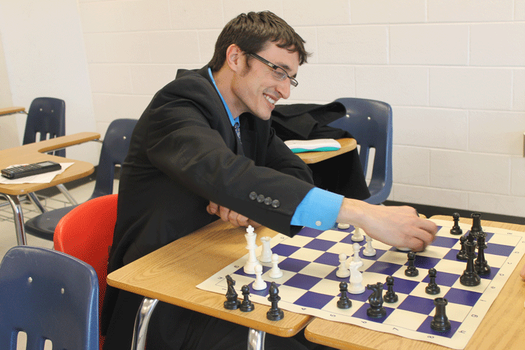 Mr. David Thaxton plays chess after school against a chess club member.