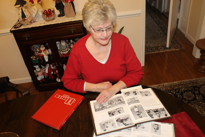 Norma Allen, Tunstall graduate, reminisces on her high school experience by looking through the first edition of the yearbook, The Iliad.