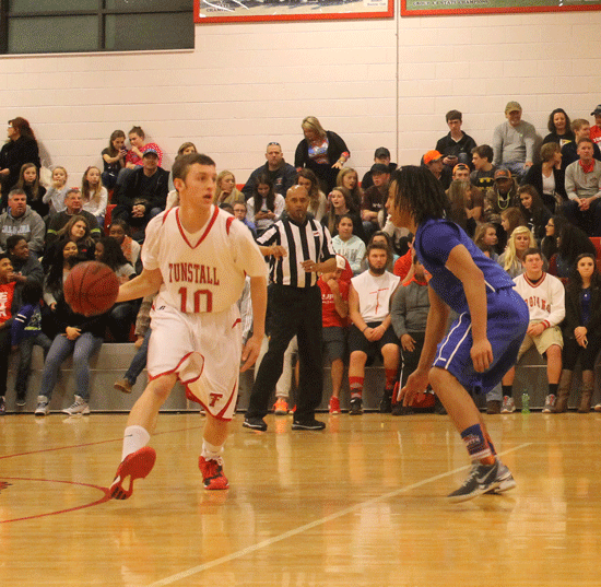 Will McGraw brings the ball up the court.