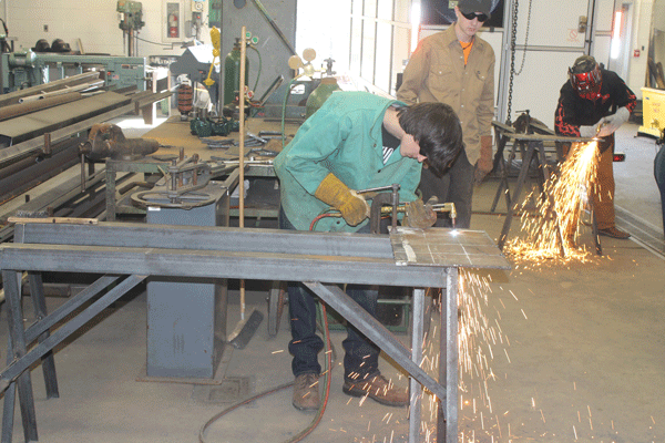 Juniors Matthew Meeks and Zach Lewis cut sheet metal as a demonstration.