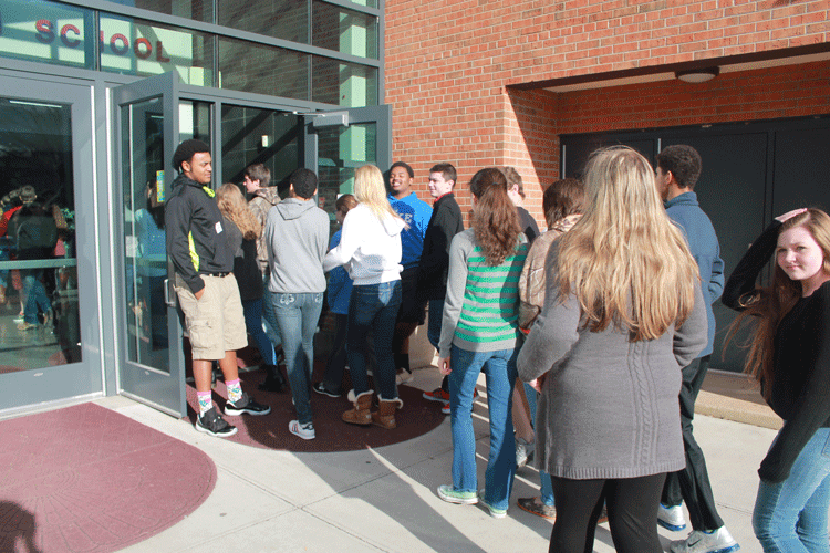 Seniors+Deshawn+Chestnut+and+Josh+Wilson+welcome+the+middle+school+tour+students.