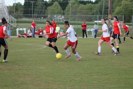 Senior Bre Carter dribbles the ball down the field. 