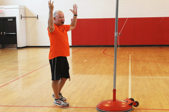 Coach Woods scores a volleyball game during his 4th period gym class.