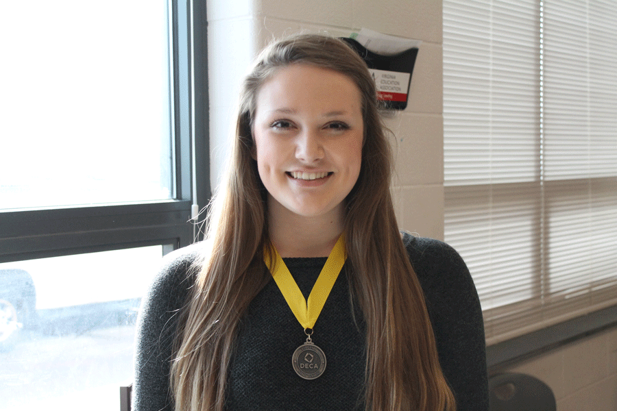 Junior Sarah Goard proudly models her medal for outstanding results in accounting.