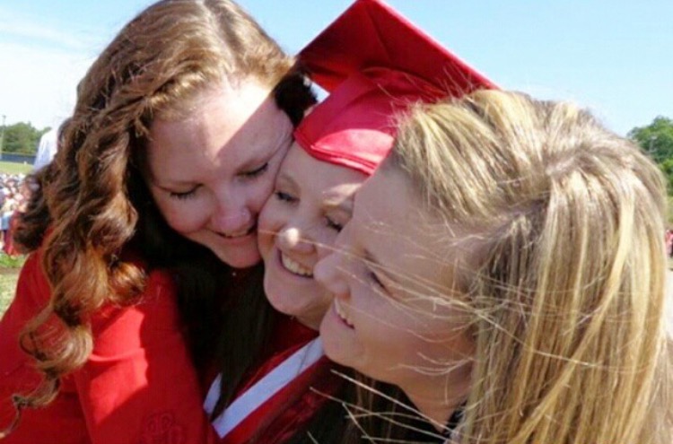 Casey, Tristan, and Abby embrace following Tristans high school graduation.  Abby is the youngest of the Scarce sisters. 