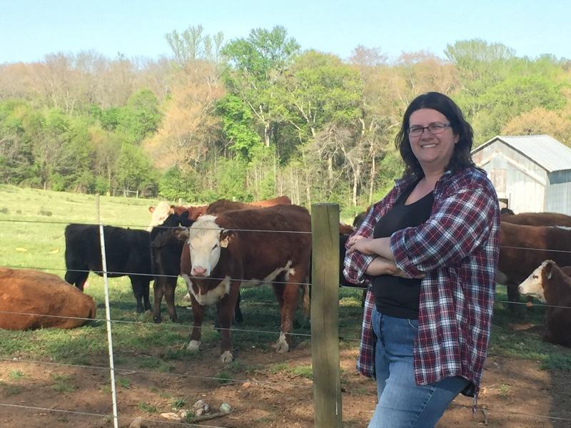 Mrs. Harris stands on her family farm. 