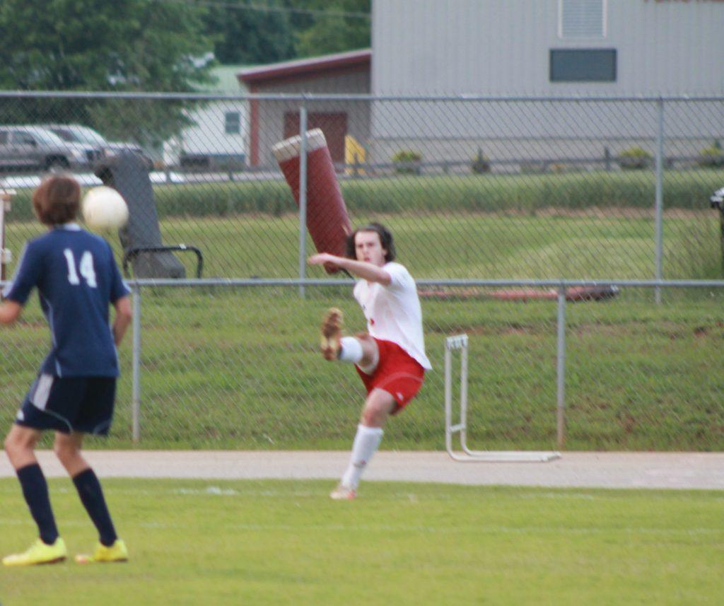 Senior Greyson Cooke executing a corner kick. 