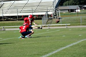 Kicker Reagan Dillon practices his field goal kicks as Miles Pyrtle holds the ball in place 