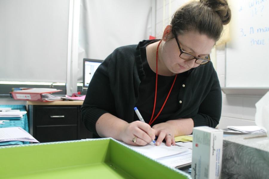 Ms. Cox grading her students papers. 