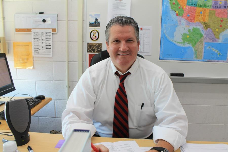 Mr. Book poses for a headshot after school. 