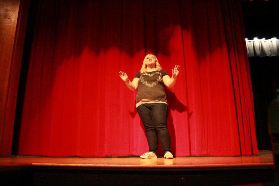 Ava wood practicing her lines on stage.