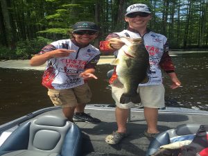 Landon and fishing partner show off his catch.