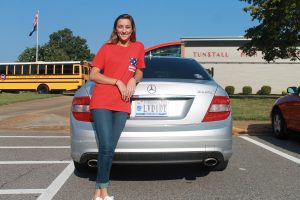 Logan McCubbins shows off her custom license plate. 