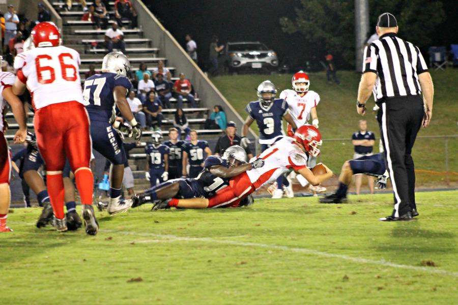 Quarterback Luke Buckner scrambles for the first down.