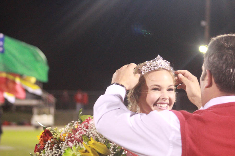 Holly receives her crown from principal Brian Boles. 