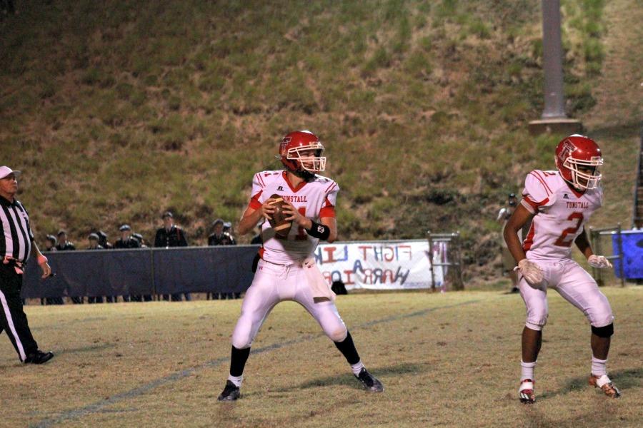 Trojans quarterback Luke Buckner (11) looks for an open receiver while running back Trevor Lovelace (2) looks for a man to block 