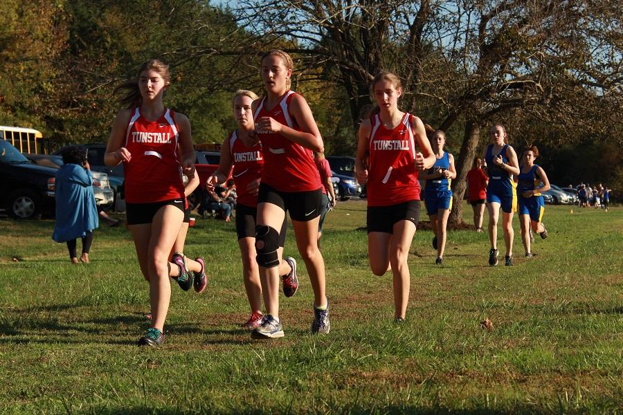 The Lady Trojans keep up their strong pack to win first place team overall.