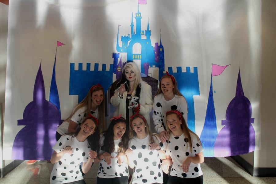 Dalmatians Lauren Van Allen, Taylor Henderson, Christina Manazares, Emily Purnell, Brooke Craddock, and Marissa Kott pose with Cruella Devil (Holland Dalton). 