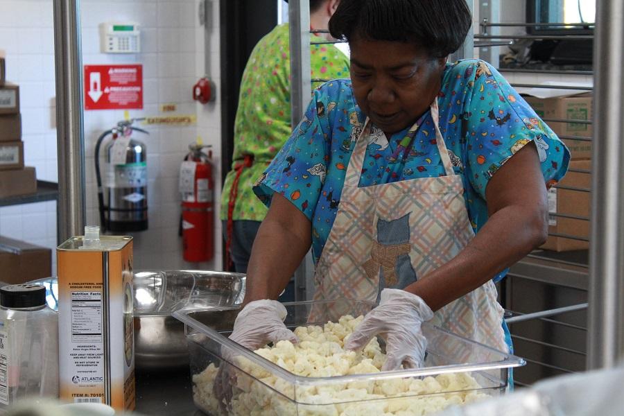 Kidd works diligently to get lunch ready for students. 