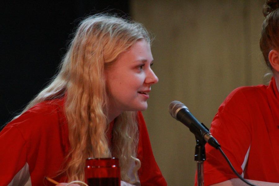 Senior Tessa Honeycutt leans into the microphone to answer a question. 