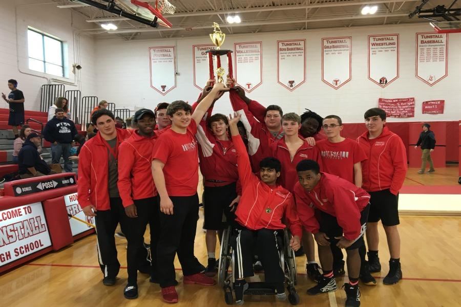 The boys receive their trophy with excitement at their last match. 