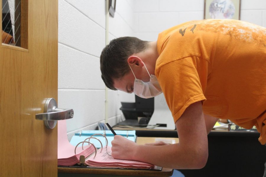 A student checks out in the attendance office after visiting the nurse. 