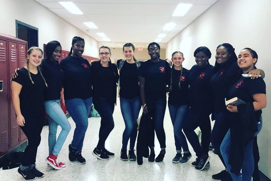 Sophomore Kayla Cousins, senior Bree Jones, senior Lauren Jackson, freshman Emily Mills, freshman Lillian Lawson, senior Alexis Hairston, senior Emma Hale, sophomore Monica Ferrell, senior Kelci Pool, and senior Mindy Duenas Salas take a group picture after a performance. 