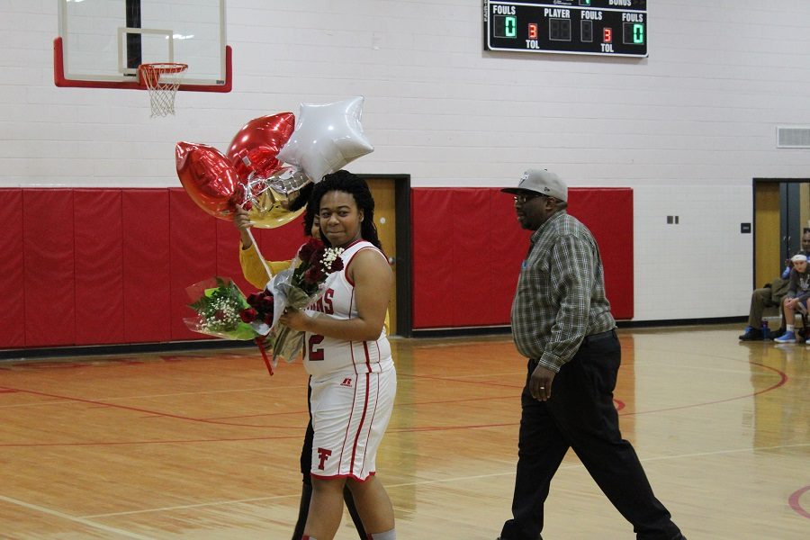 Senior Makayla Gravely walking off the court after being recognized.