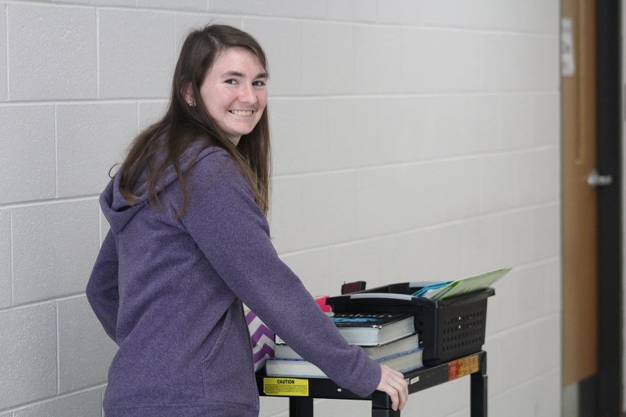 Miss Brown poses with her classroom on wheels.