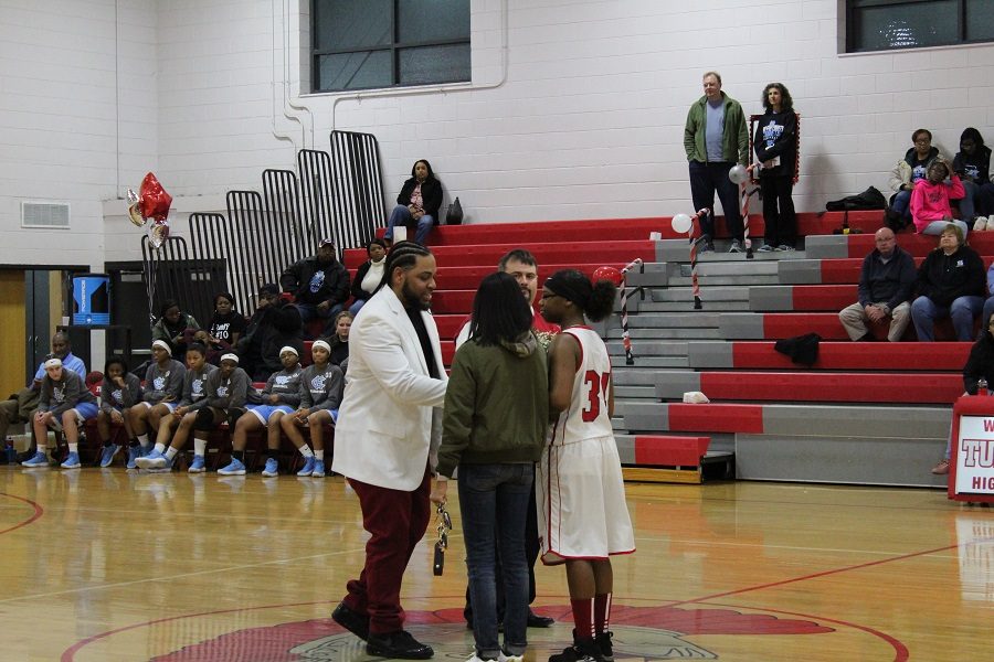 Shakayla James shaking coach Hairstons hand.