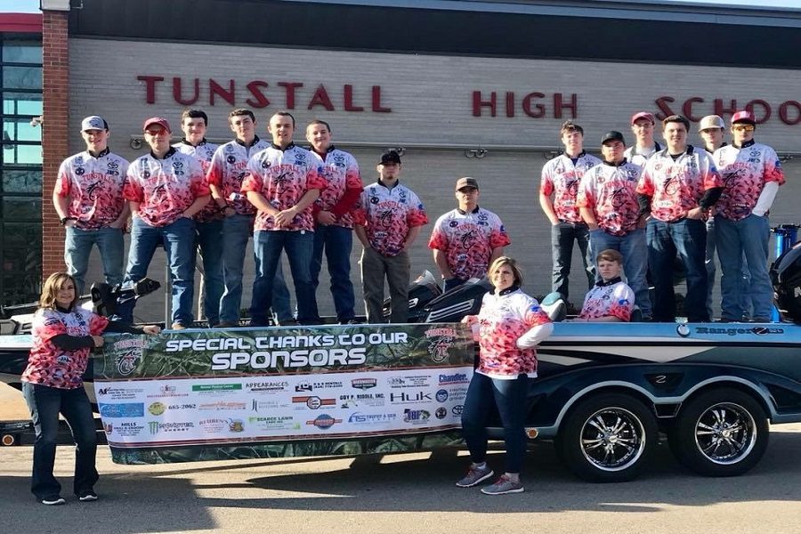 The fishing club takes a group picture before heading to a tournament. 