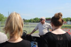 Deputy Silverman talks to students in a Drivers Ed class before they participate in a drunk driving simulation with a golf cart. 