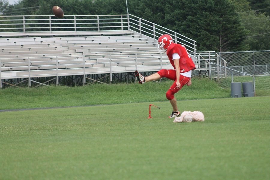 Senior Zach Mensavage practicing kicking and punting 