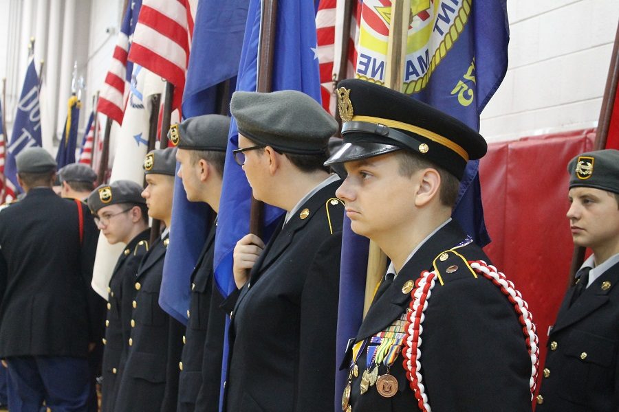 Junior Logan Hutchinson standing for the presentation of colors