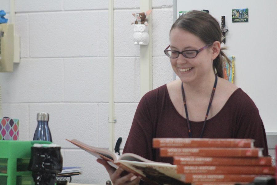 Ms. Brittany Atkins reviewing her World History 1 book