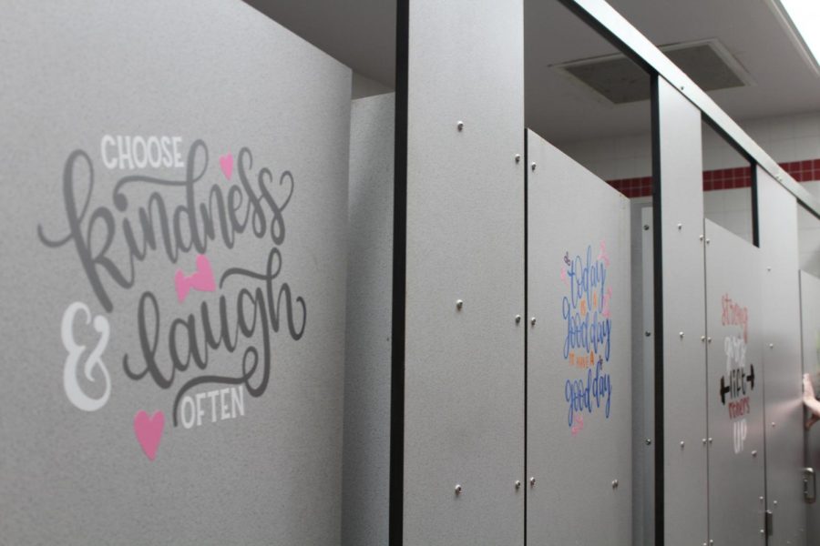 Decals posted on the stall doors of the bathroom were added by Beta to encourage positivity. 