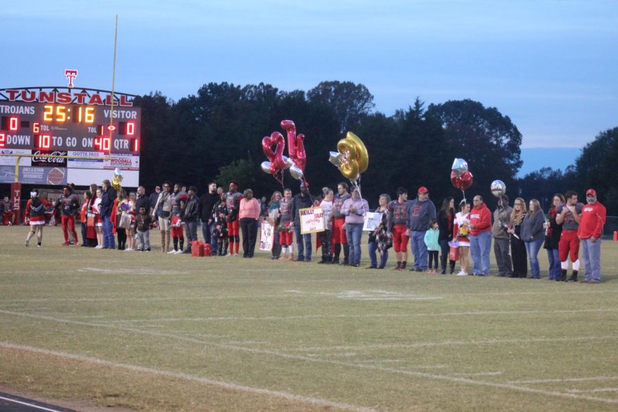 Parents are lined up with their seniors.