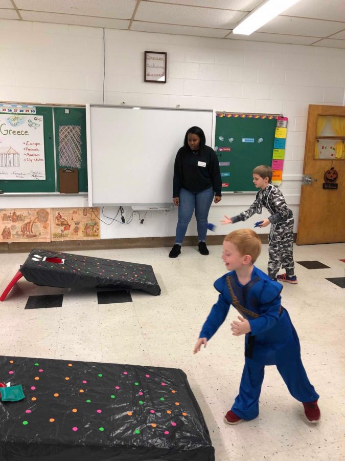 Senior Mariah Venable assists with the cornhole game. 