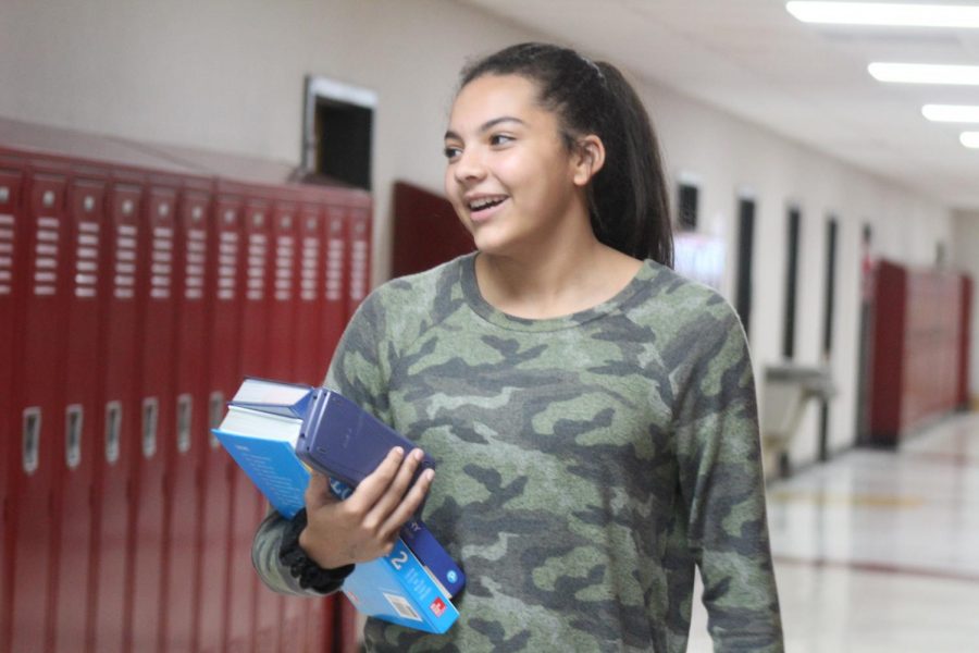 Adrien Glass carries her books to class. 