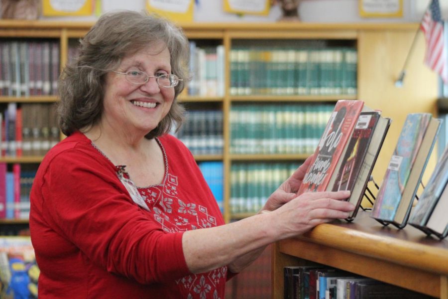 Librarian Linda Yeatts organizes library books