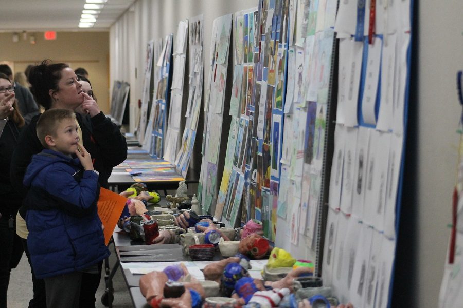 Mrs. Scott and her son looking at art