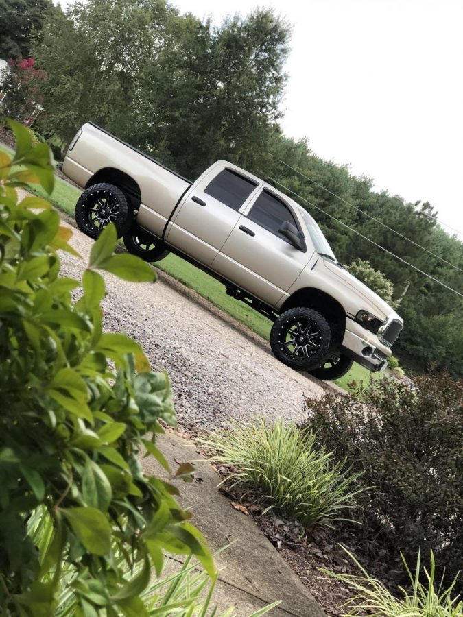 Senior Ethan Broyles modified gold Dodge Ram Hemi crew cab. 