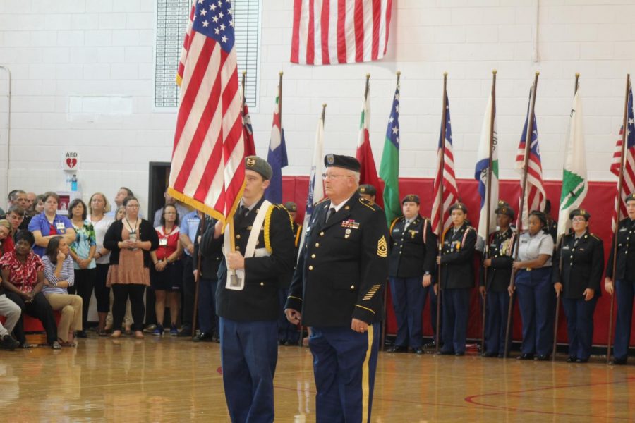 Junior Brandon Day presenting the United States of America flag accompanied by Sgt. Major Hubert Royall.  