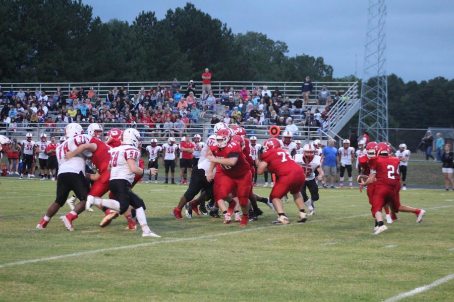 The Trojan football team looks to run the ball against rival Chatham. 