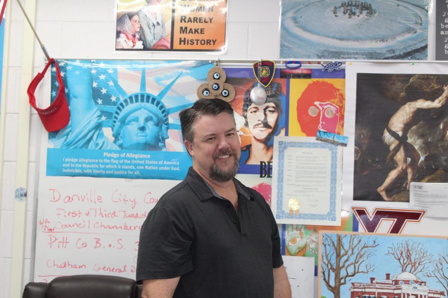 Social studies teacher Patrick Touart laughing while sporting his signature goatee.