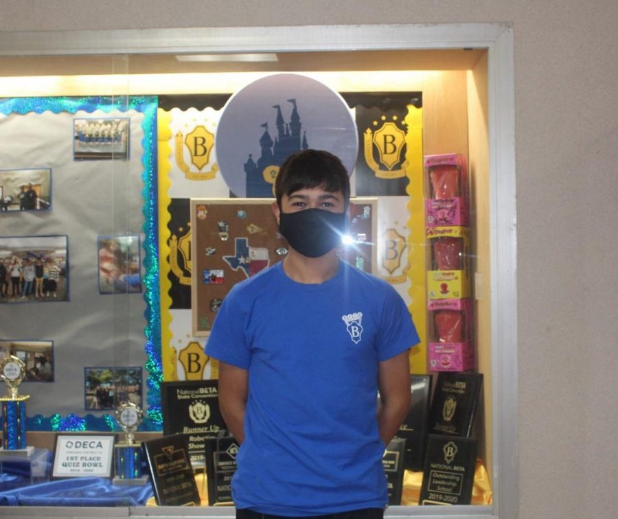 John Mills in his 2020 BETA convention shirt in front of the BETA memorabilia .