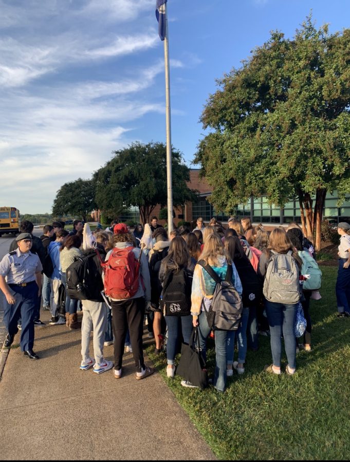 Students gather around the flag and have an early morning worship.