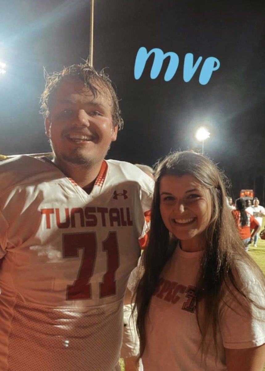 Senior Evan Lewis posing at a football game with alumni Katie Vipperman. 