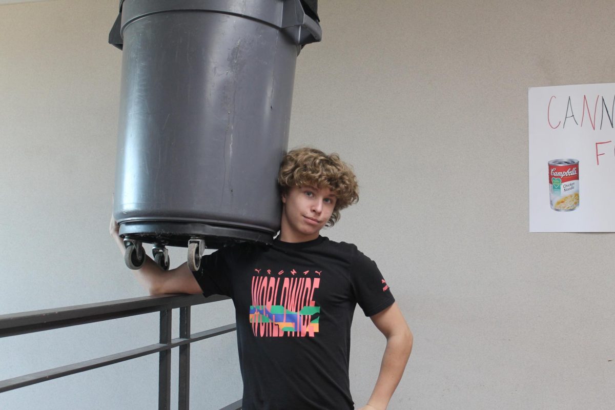 Sophomore Cole Payne posing with a trash can. 